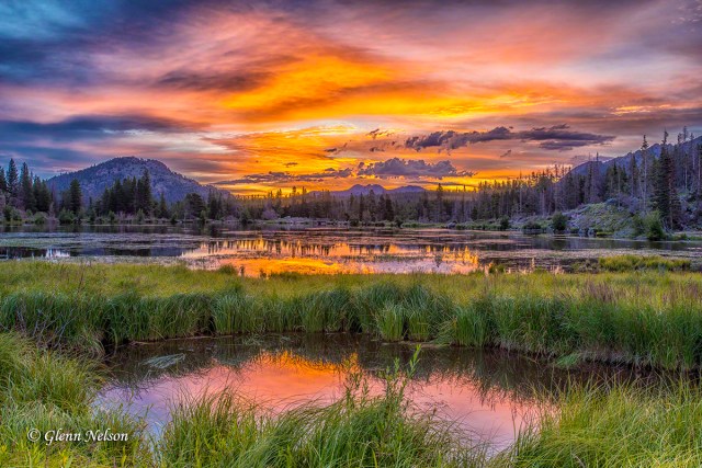 The sun rises over Sprague Lake in Rocky Mountain National Park.