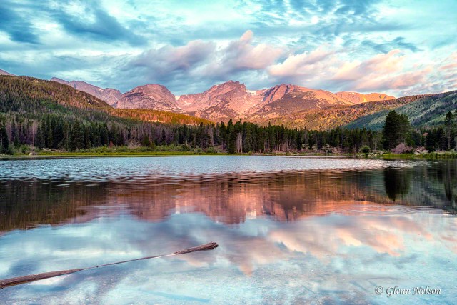 The rising sun reflects off the peaks on the east side of Sprague Lake.