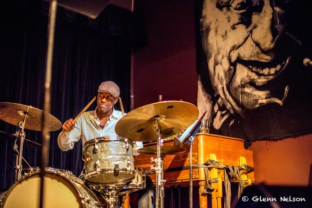 Donald Edwards on drum, with an "only-at-The-Royal-Room" backdrop.